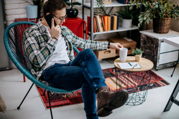 istock Man checking social media and drinking coffee at home 1349465242