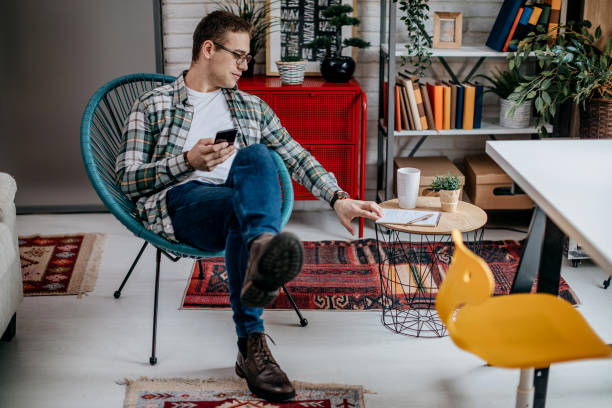 istock Man checking social media and drinking coffee at home 1349465243