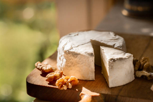 istock Brie cheese or camembert on cheese platter with walnuts. Closeup view, selective focus 1349468620