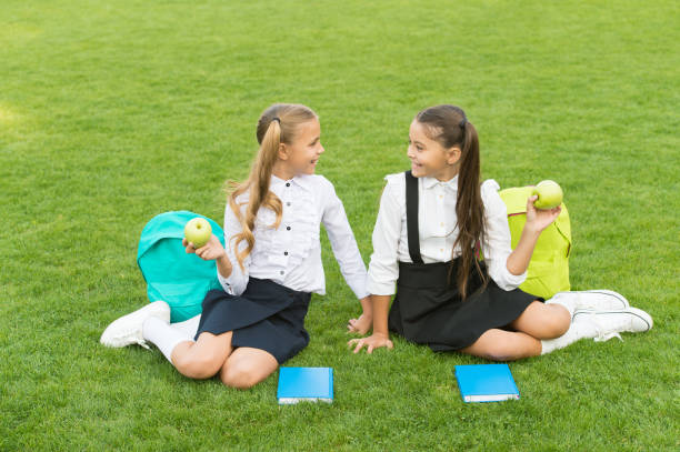 istock School friends relaxing after classes at school yard, school break concept 1349468728
