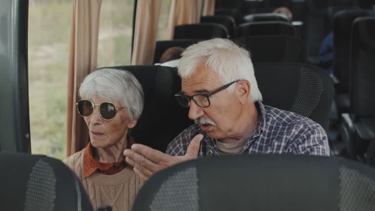 Senior Couple Talking in Bus