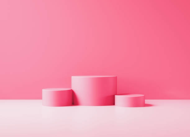 istock Pink Podiums Sitting Before Pink Wall Background 1349471103