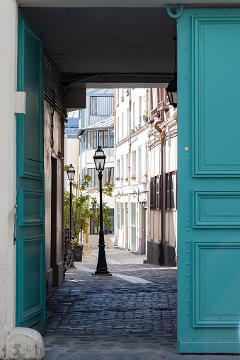 Paris, an opened wooden door, with a charming courtyard