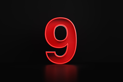 Red number nine sitting on before black background. Horizontal composition with copy space.