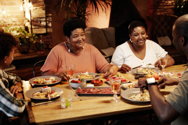 istock Family Enjoying Dinner at Table 1349472248