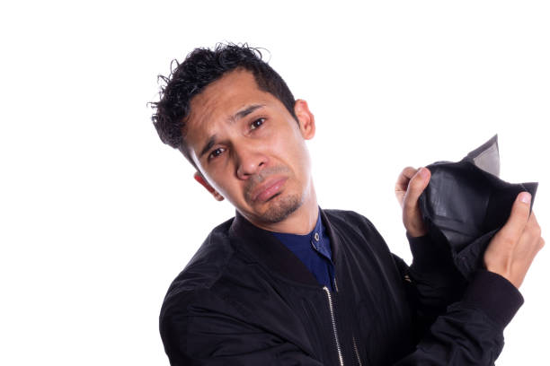 Sad man showing camera his empty wallet, Isolated on white background. Expression of Young adult frustrated because he has no money or savings.