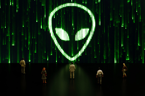 Businessman/politician figurines examine a matrix style alien symbol. Artificial intelligence/technology/digital age concept