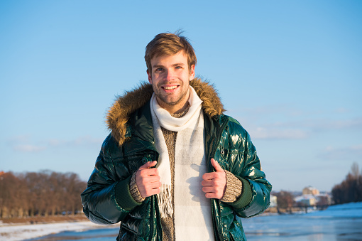 Recreation concept. Active leisure. Handsome man traveling in winter. Warm clothes for cold season. Winter fashion. Winter holidays. Walking snowy nature background. Man enjoy january outdoors.