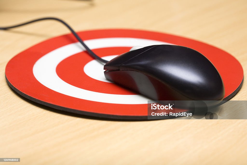 IT target Hit your computing target! Mouse on a bullseye mouse mat. Symbolize your digital business goals with this concept photo. Mouse Pad Stock Photo