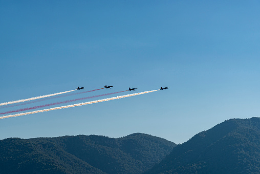 Military warplanes demonstrating in the air on mountains for Republic Day celebrations in Turkey.