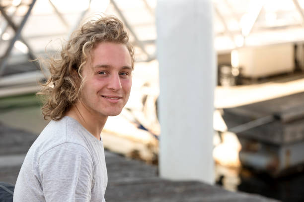 istock Portrait of modern, happy,  young man, looking at camera, background with copy space 1349483032