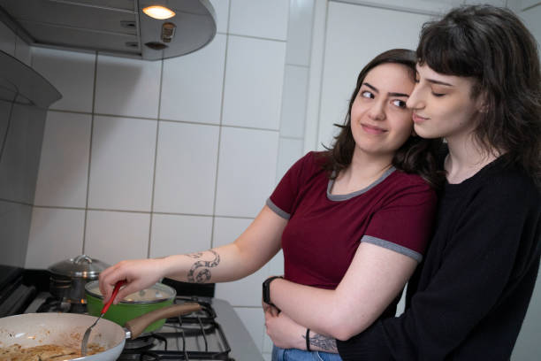 istock Lesbian couple cooking together. 1349483224