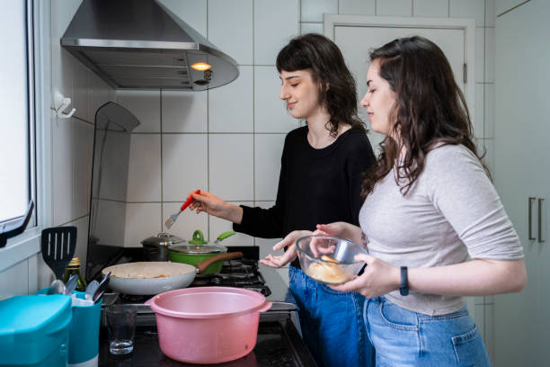 istock Lesbian couple cooking together. 1349483235