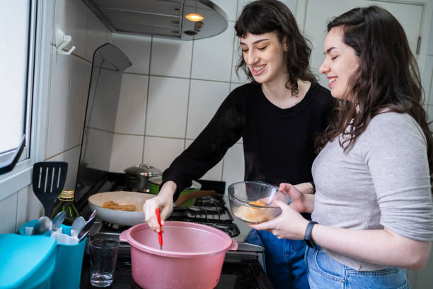 istock Lesbian couple cooking together. 1349483245