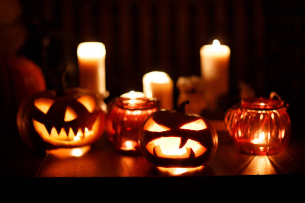 istock Making Halloween pumpkin Jack-o-lantern. Pumkins and candles on table 1349485894