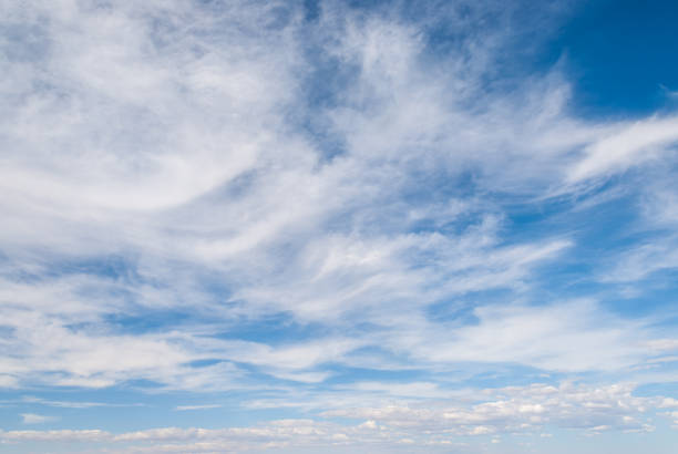 Cirrus Clouds in a Blue Sky Cirrus clouds appear in a blue sky over Petrified Forest National Park near Holbrook, Arizona, USA. jeff goulden petrified forest national park stock pictures, royalty-free photos & images