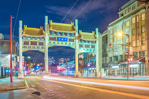 Melbourne, Australia - Aug 29, 2022: Night view of Chinatown (Little Bourke Street). Feature traditional street red lanterns. Shops and pedestrians line both sides of the narrow street.