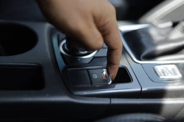 istock hand pulling the car handbrake lever when the car is parked 1349490237