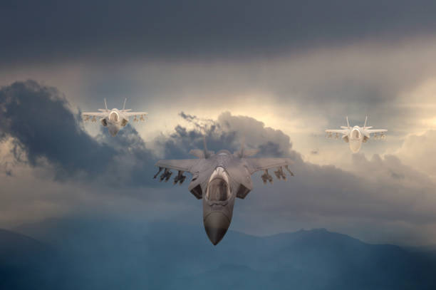 istock Three F-35 fighter jets flying over clouds 1349492415
