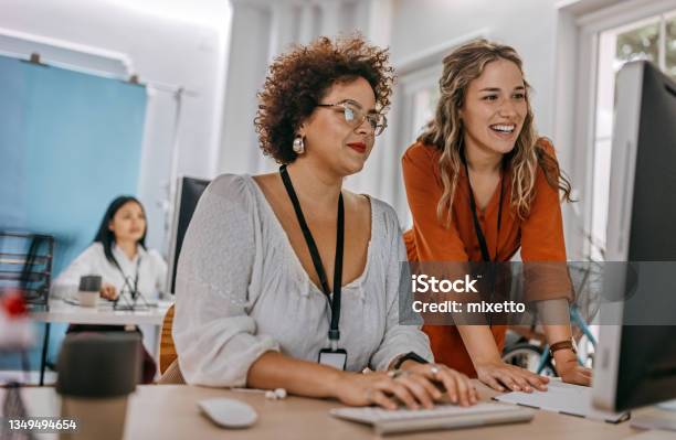 Two Business Colleagues Working Together On Desktop Computer At Office Stock Photo - Download Image Now