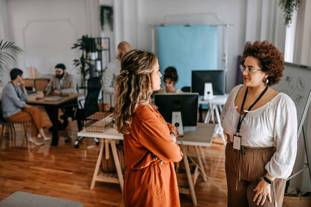 istock Two women employees discussing in meeting at office 1349496884