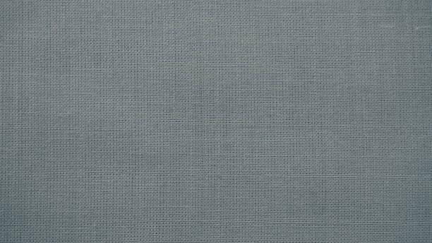 istock Texture canvas fabric as background. Gray sackcloth. Grey linen scrim 1349503224