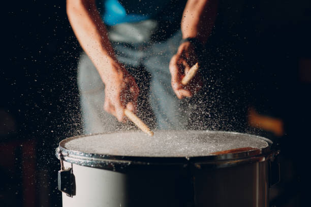 istock Drum sticks drumming beat rhythm on drum surface with splash water drops 1349503264