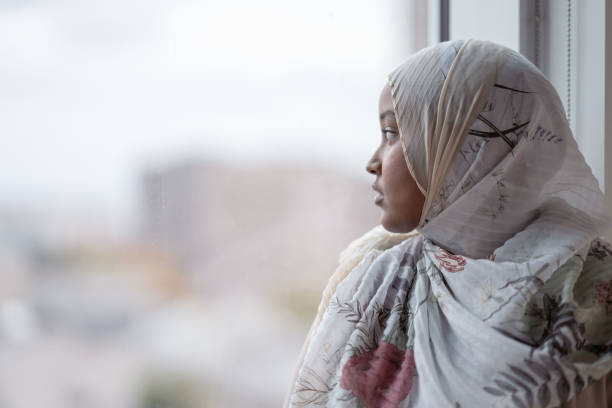 istock Muslim Woman Looking Out the Window 1349504225