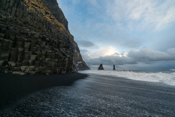 istock Basalt rock formations Troll toes on black beach. at storm Reynisdrangar, Vik, Iceland 1349520561