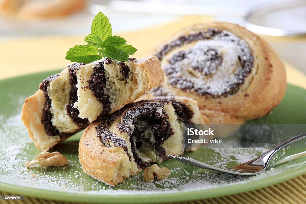 Poppy seed snails Breakfast pastry - Poppy seed snails dusted with icing sugar Baked Stock Photo