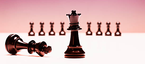 istock Triumphant chess queen conquers fallen king 134954898