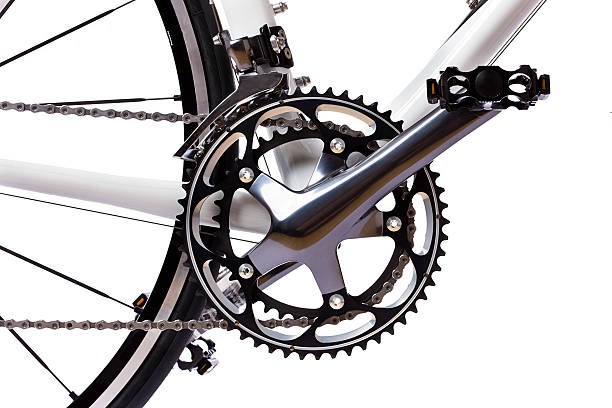 Racing bike detail Pedal, crank, front sprockets and derailleur shot on a white background in the studio. The bike is a brand-new top model worth thousands of dollars. Camera: Canon EOS 1Ds Mark III. gear mechanism photos stock pictures, royalty-free photos & images
