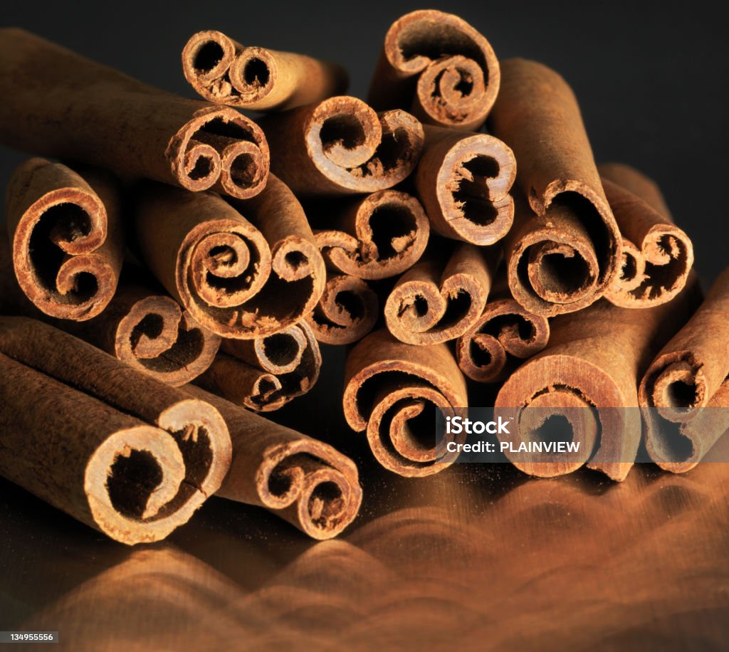 Cinnamon sticks Sticks of cinnamon reflected on a metal background Brown Stock Photo