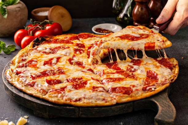 istock Pepperoni pizza with a slice taken out with cheese pull 1349560402