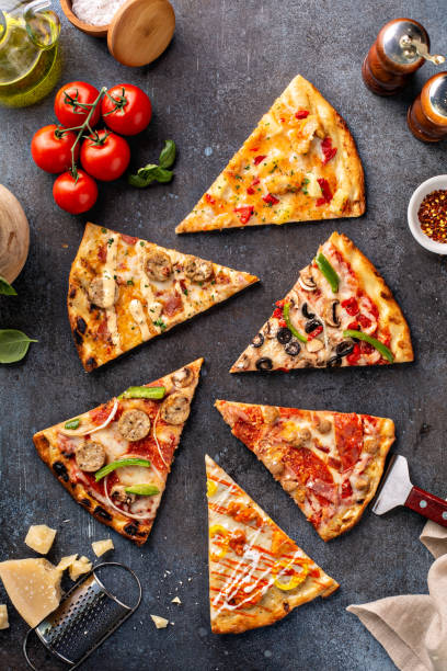 istock Variety of pizza slices top view 1349560403