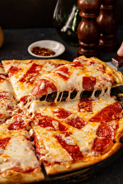 istock Pepperoni pizza with a slice taken out with cheese pull 1349560408