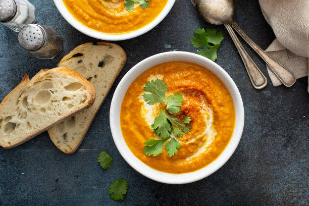 istock Pumpkin soup served with cream and cilantro 1349560828
