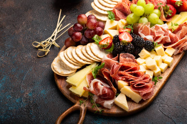 istock Cheese or charcuterie board on dark background 1349560868