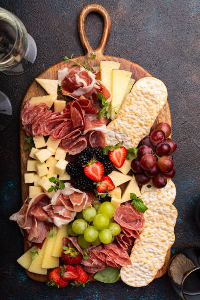istock Cheese or charcuterie board on dark background 1349560881