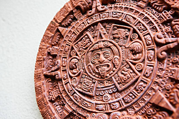 Stone of the Sun plaque: angled, cropped view The Aztec calendar stone known as the Stone of the Sun. The original, carved in basalt, was excavated in Mexico City in 1790. This is a modern ceramic reproduction. The stone has become an informal national symbol of Mexico. Shot with EOS 1Ds Mark III. tonatiuh stock pictures, royalty-free photos & images