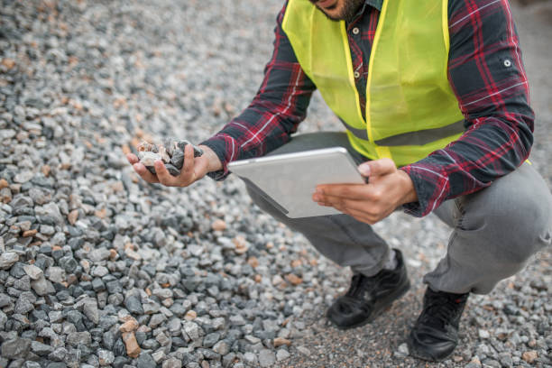 istock Close-up of a quarry worker examining a stone he has found 1349566298