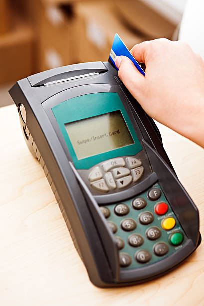 istock Close up as woman's hand swipes credit card through reader. 134956775