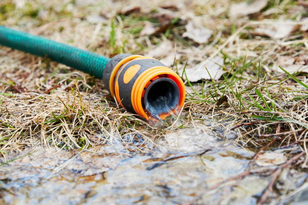 water flows from the hose to the vegetable garden. Gardening supplies and garden care