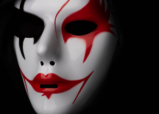 istock Scary mask for Halloween hand sprayed by photographer with dramatic lighting and black background 1349579645