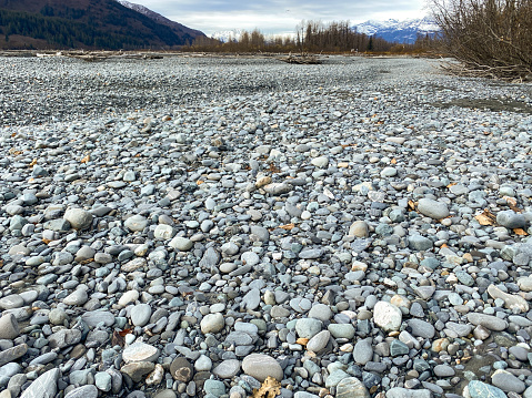 The beauty of a dry river bed.  River rocks produce a variety of colors and textures. These rocks provide a beautiful background.