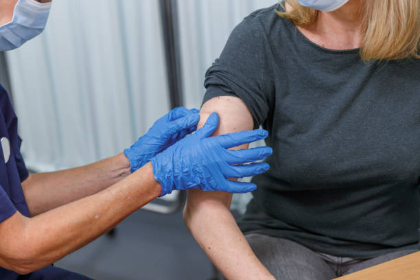 istock Nurse placing bandage on patient after giving COVID-19 vaccination 1349580430