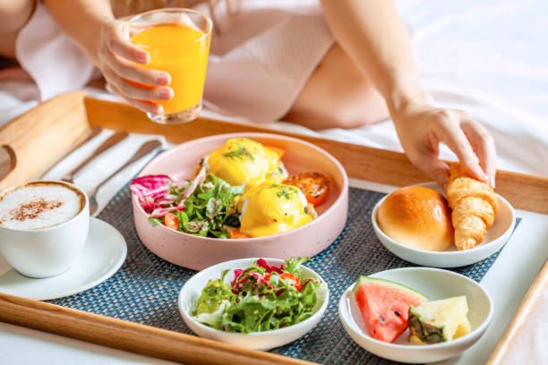 istock Breakfast in Bed with Coffee, Orange Juice, Salad, Fruits and Eggs Benedict 1349582414