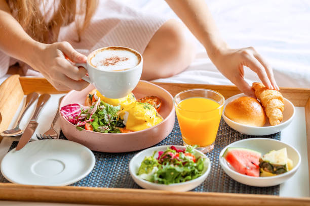 istock Breakfast in Bed with Coffee, Orange Juice, Salad, Fruits and Eggs Benedict 1349582962