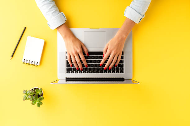 istock Office desktop with woman’s hands working on laptop. Business background with accessories 1349583961