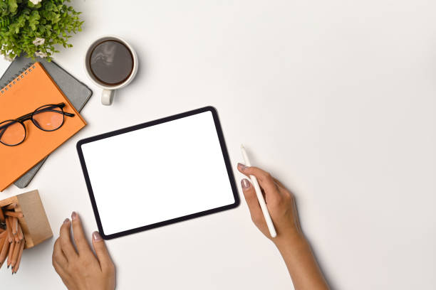istock Woman holding stylus pen and working with digital tablet. 1349588157